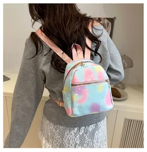 Detail of tie-dye mini backpack with heart embroidery and metallic zipper for women