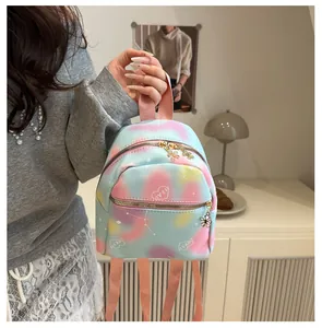 Detailed close-up of pink, blue, and yellow gradient mini backpack with flower zipper