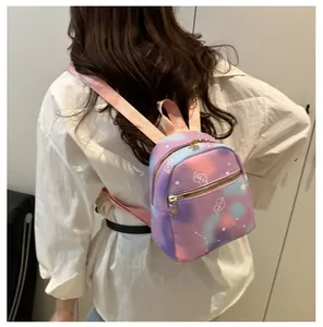 Detail of mini gradient backpack with heart patterns and gold metallic zippers