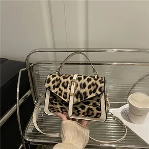 Modern leopard print shoulder bag with gold clasp and sleek PU leather finish
