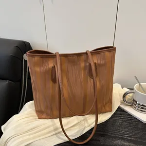 Chic caramel brown tote bag with water ripple texture and long shoulder straps for daily use