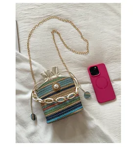 Close-up of woven bucket bag with pearl detail and colorful horizontal stripes
