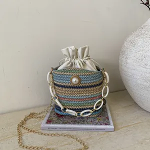 Fashionable multi-color woven bucket bag with pearl accent and golden chain strap