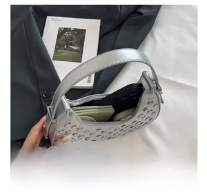 Detail show of silver moon bag interior with metal rivets and daily essentials capacity