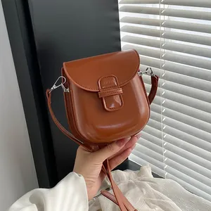 Borsa a tracolla chic in pelle sintetica marrone caramello con patta curva e cinturino