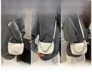 Versatile white crescent bag with silver chain, shown in handheld, crossbody and shoulder styles