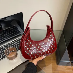 Deep red moon hobo bag with silver rivets and sleek leather finish for women