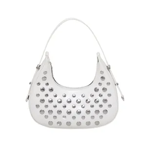 White leather hobo bag with silver metal rivets shown on a clean studio background
