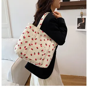 Close-up of strawberry print corduroy tote bag showing large capacity and soft texture