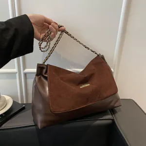 Brown patchwork shoulder bag with chain strap and gold hardware for daily commute