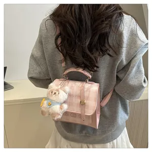 Pink checkered mini backpack with bear charm shown from a stylish back view perspective