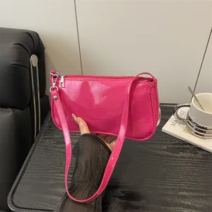 Glossy pink patent leather baguette bag for women with silver zipper and slim strap