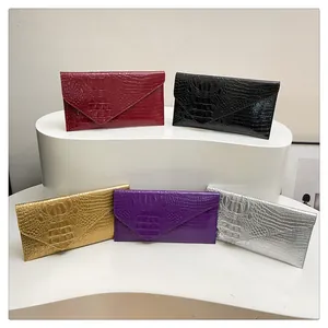 Five colors of elegant crocodile-pattern envelope clutches on a tiered display stand
