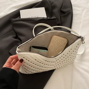 Interior view of white quilted crossbody bag showing spacious capacity for phone and wallet