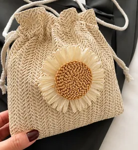 Detailed view of woven bucket bag with large 3D sunflower and drawstring closure