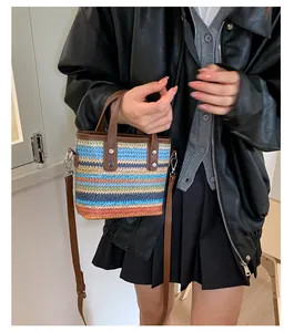 Detail der bunten gewebten Beuteltasche mit braunem Lederriemen und Streifenmuster