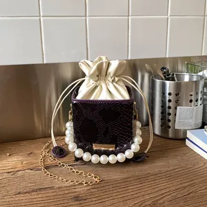 Borsa a secchiello viola con stampa serpente, manico di perle e fodera interna