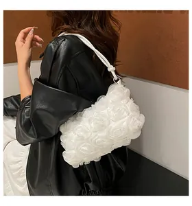 Close-up of elegant 3D white fabric rose floral shoulder bag with delicate ruffled texture