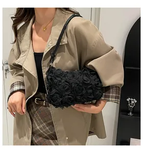 Detailed view of 3D fabric black rose floral texture on elegant shoulder bag
