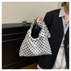 Detailed view of large polka dot shoulder bag made of durable smooth nylon fabric