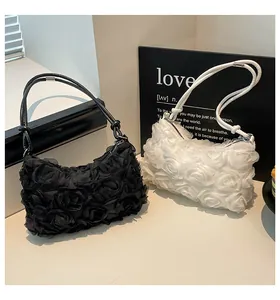 Detail of 3D rose flower handbags in black and white with top zipper closure