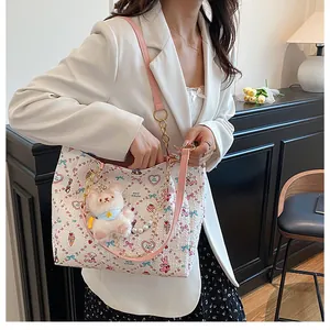 Detail view of white bubble fabric tote bag with cute cartoon prints and pink leather strap
