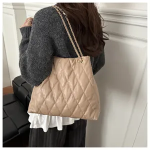 Detail of light khaki quilted chain bag showing the soft texture and chain strap