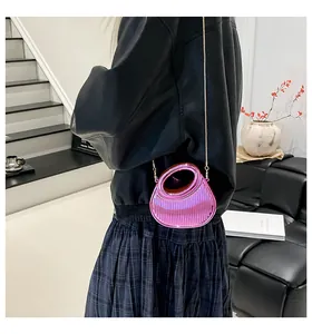 Détail du sac de soirée rose métallisé avec plis verticaux et chaîne dorée