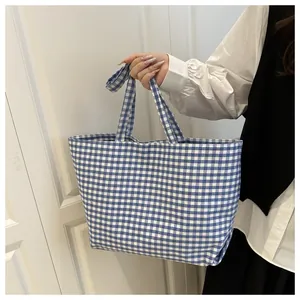 Blue and white checkered canvas tote bag with spacious interior for daily casual use