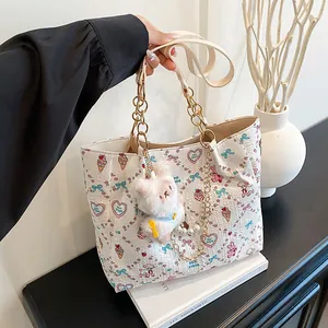 Chic white square tote bag with colorful cartoon prints and plush rabbit pendant
