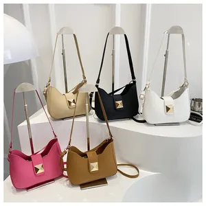 Detail shot of synthetic leather shoulder bags with single square metal stud decoration