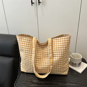 Yellow and white checkered canvas tote bag for women showing spacious summer casual style