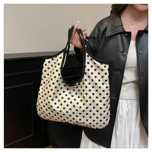 Polka dot pattern tote bag detail showing lightweight fabric and spacious design