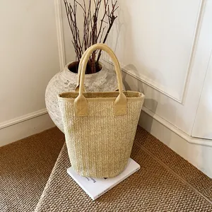Minimalist straw bucket handbag with V-weave texture for fashion and commute