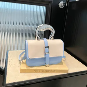 Chic two-tone crossbody bag with silver curved metal handle and adjustable strap