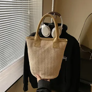 Elegant straw bucket bag with sturdy top handles for summer beach or daily commute fashion