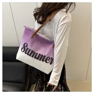 Detail of purple gradient canvas tote bag featuring Summer lettering and fringed edges