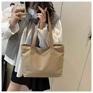 Practical large-capacity beige tote bag shown on model for daily commuting style