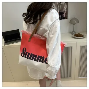 Detail of red and white gradient canvas tote with Summer print and fringe edges