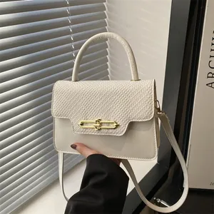 Chic cream leather handbag with lizard pattern flap and elegant gold metal lock clasp