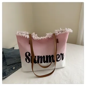 Detail of pink gradient canvas tote bag with Summer print and fringe edges on white background