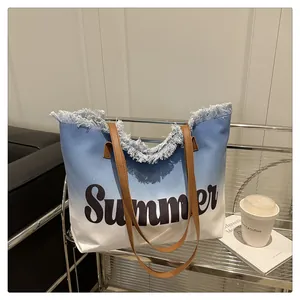 Detail of blue and white gradient canvas tote bag with Summer print and fringe edges