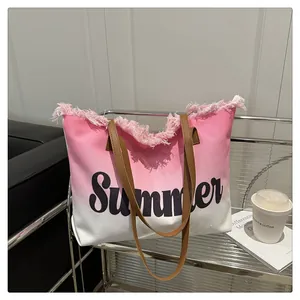 Close-up of pink and white gradient canvas tote with fringe and Summer script logo