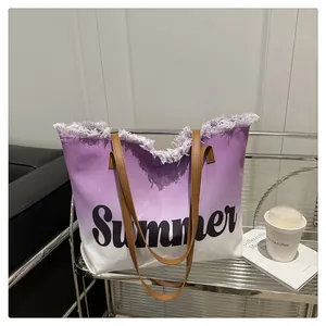 Detailed macro view of frayed edges and purple gradient canvas on summer tote bag