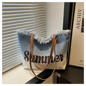 Detailed shot of frayed fringe edges and Summer print on blue gradient canvas tote bag