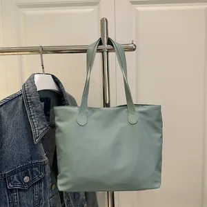 Minimalist mint green large capacity nylon tote bag hanging with denim jacket