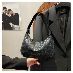 Detail shot of black woven leather tote bag with classic hobo silhouette and zip closure