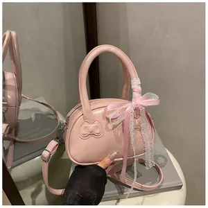 Close-up of pink patent leather bag with 3D bow texture and sweet lace ribbon detail