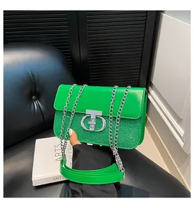 Detail of green sequin shoulder bag with metallic chain and silver brand logo buckle