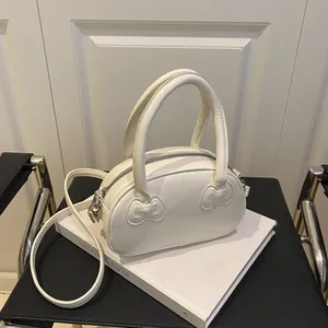 Elegant white leather bowling bag with bow-knot details and crossbody strap